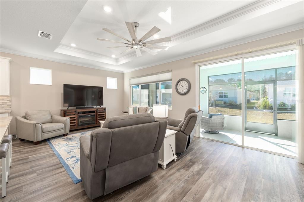 10390 Southwest 99th Street Ocala, FL 34481 - Photo 27 of 48 a living room with furniture and a flat screen tv