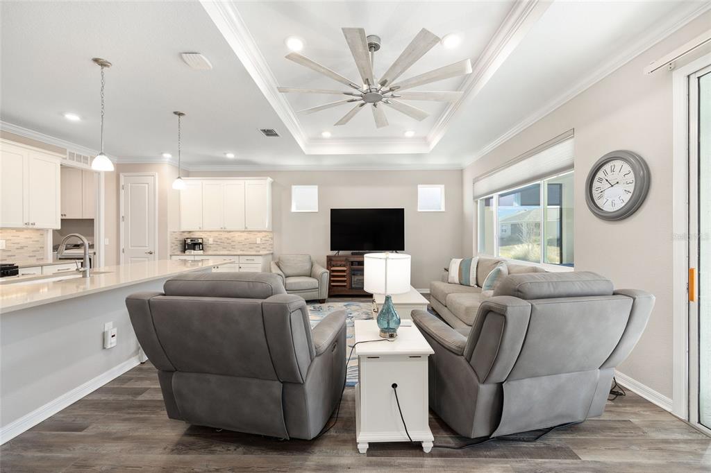 10390 Southwest 99th Street Ocala, FL 34481 - Photo 28 of 48 a living room with furniture a flat screen tv and a large window