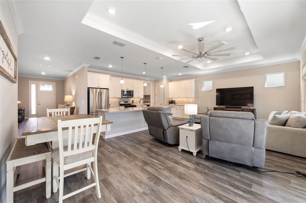 10390 Southwest 99th Street Ocala, FL 34481 - Photo 31 of 48 a living room with furniture a flat screen tv and kitchen view