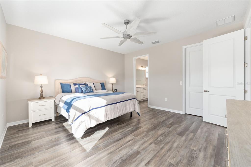 10390 Southwest 99th Street Ocala, FL 34481 - Photo 38 of 48 a bedroom with a bed and a ceiling fan