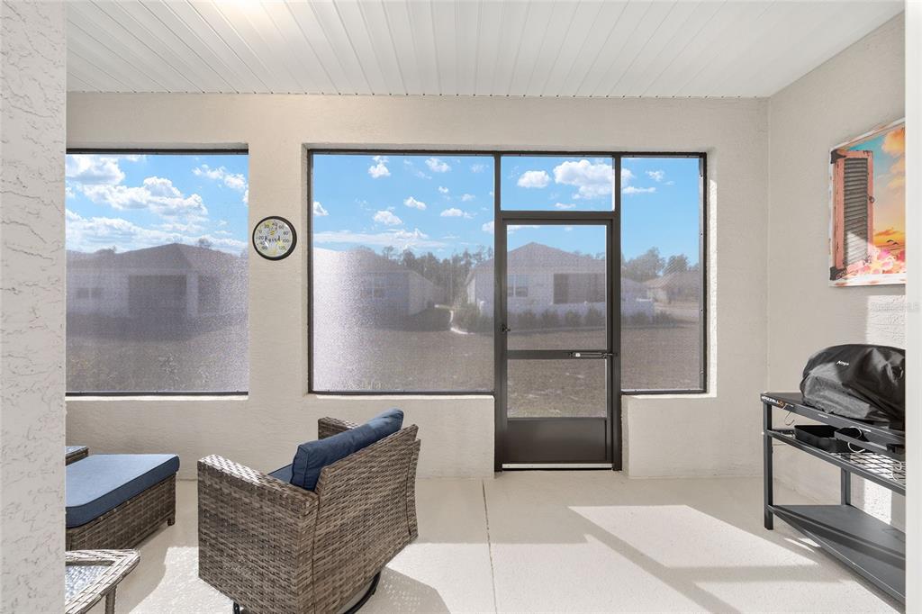10390 Southwest 99th Street Ocala, FL 34481 - Photo 44 of 48 a living room with furniture a rug and a large window