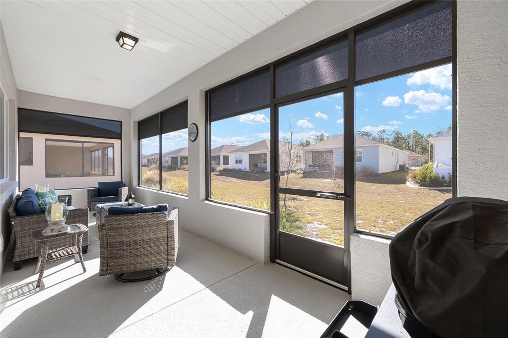 10390 Southwest 99th Street Ocala, FL 34481 - Photo 45 of 48 a room with furniture and large windows