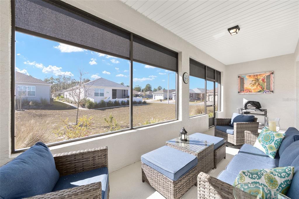 10390 Southwest 99th Street Ocala, FL 34481 - Photo 48 of 48 a living room with furniture and a floor to ceiling window