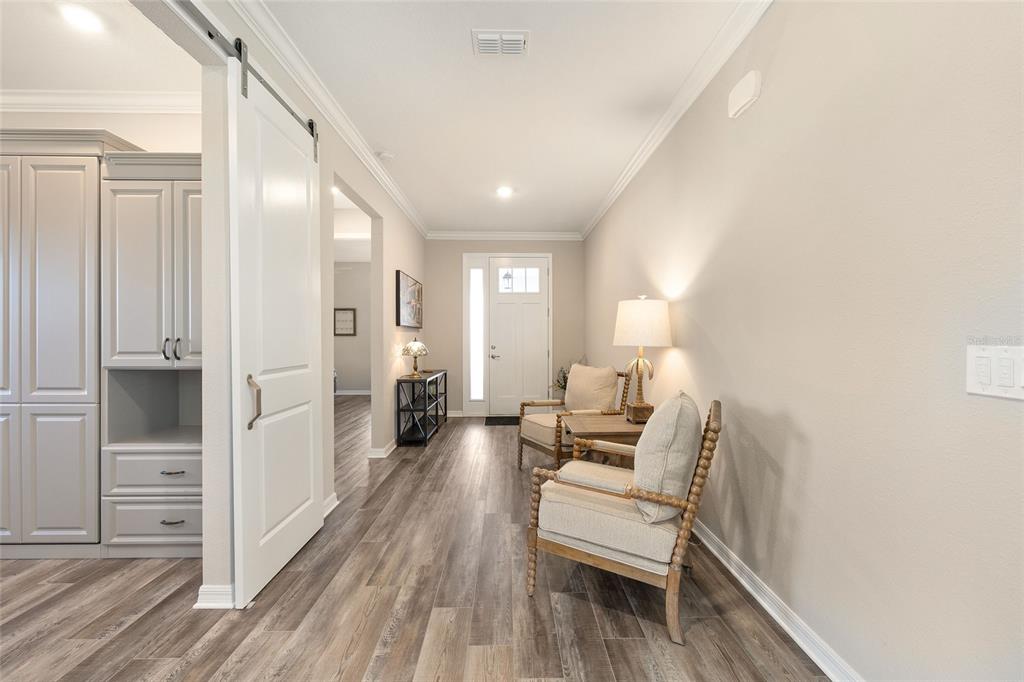 10390 Southwest 99th Street Ocala, FL 34481 - Photo 10 of 48 a living room with furniture and a wooden floor
