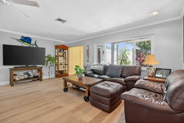 a view of a dining room with furniture and a chandelier