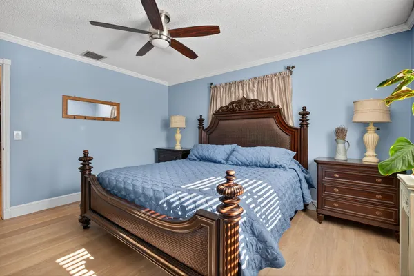 a bedroom with a bed and wooden floor