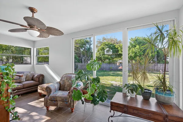 a view of a patio with table and chairs and couches with wooden floor