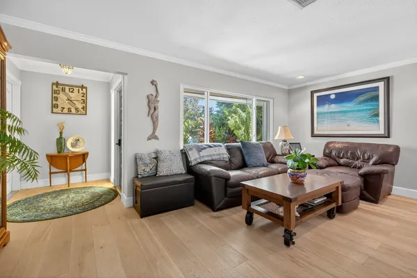 a living room with furniture and wooden floor