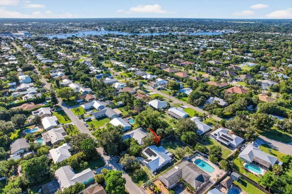 an aerial view of a house with a yard and garden