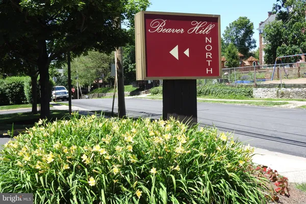 a sign that is sitting in front of flowers