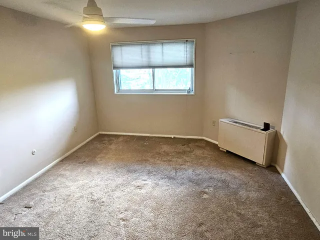 a bedroom with a bed and a window in it