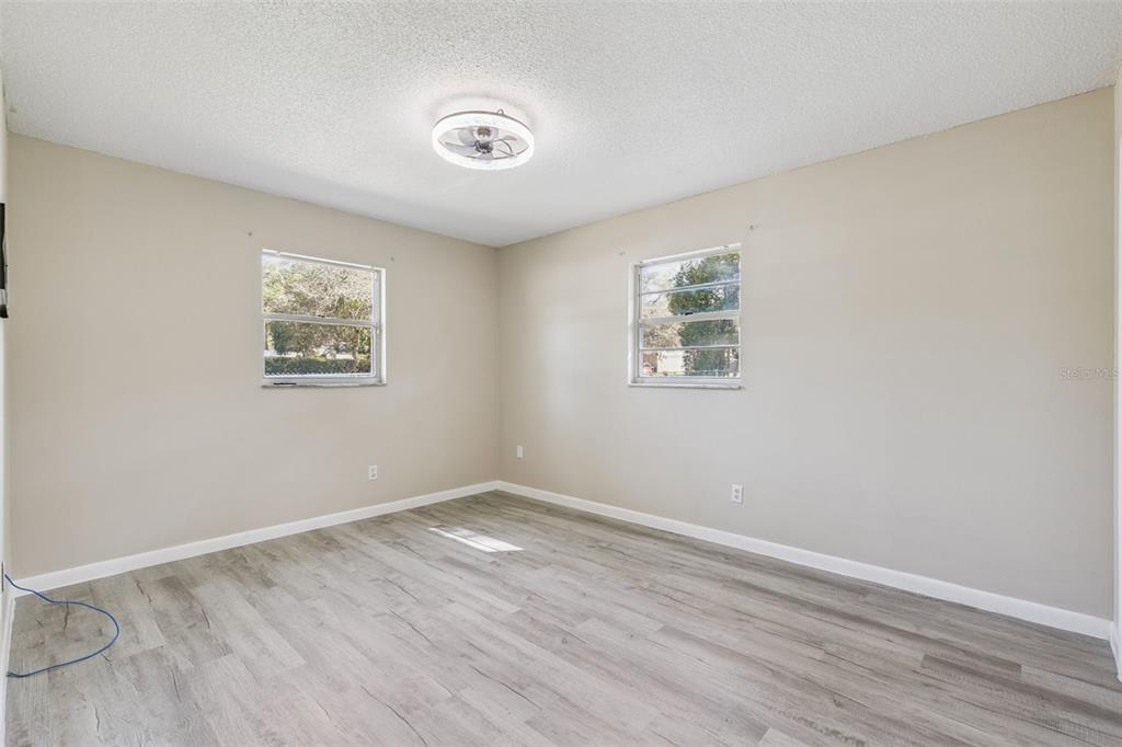 111 Amigos Road DeBary, FL 32713 - Photo 13 of 29 a view of a big room with wooden floor and windows
