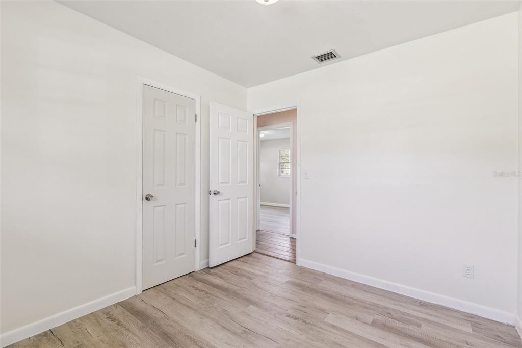 111 Amigos Road DeBary, FL 32713 - Photo 16 of 29 a view of an empty room with wooden floor