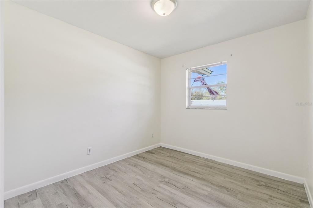 111 Amigos Road DeBary, FL 32713 - Photo 17 of 29 an empty room with wooden floor and window
