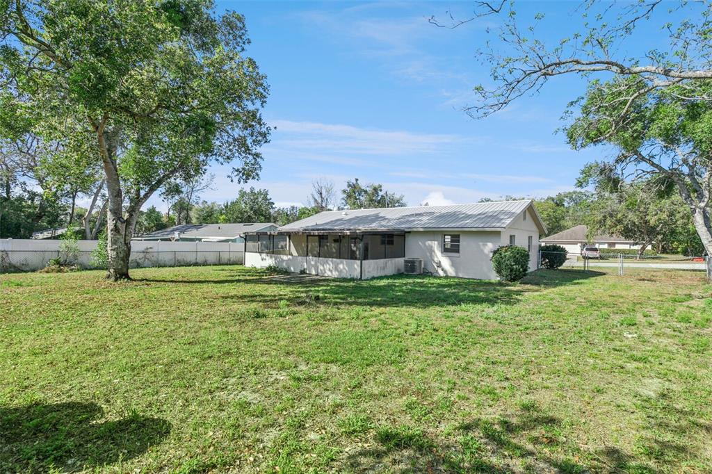 111 Amigos Road DeBary, FL 32713 - Photo 25 of 29 a front view of a house with a yard