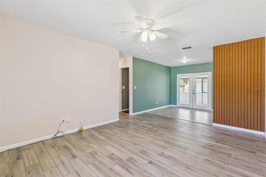 111 Amigos Road DeBary, FL 32713 - Photo 5 of 29 wooden floor in an empty room with a window