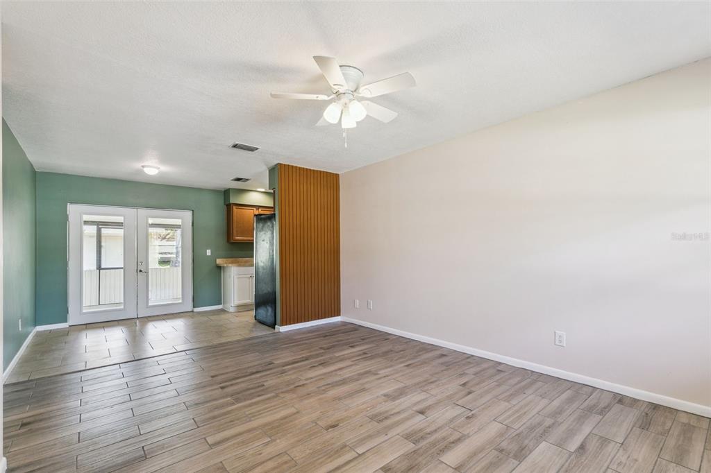 111 Amigos Road DeBary, FL 32713 - Photo 6 of 29 a view of empty room with wooden floor and fan