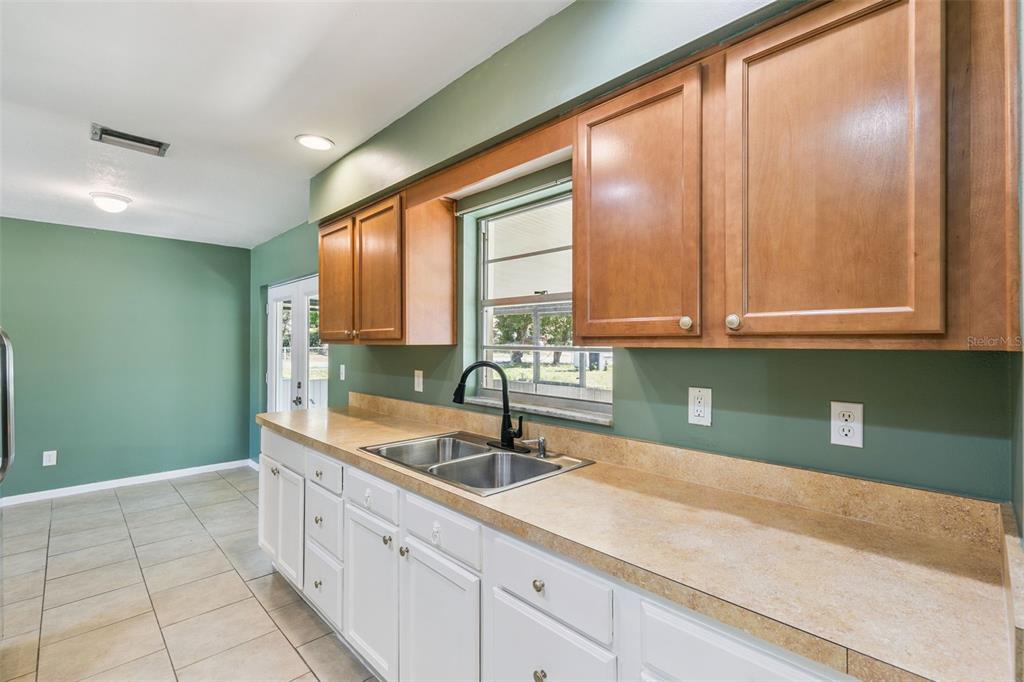 111 Amigos Road DeBary, FL 32713 - Photo 9 of 29 a kitchen with a sink and cabinets