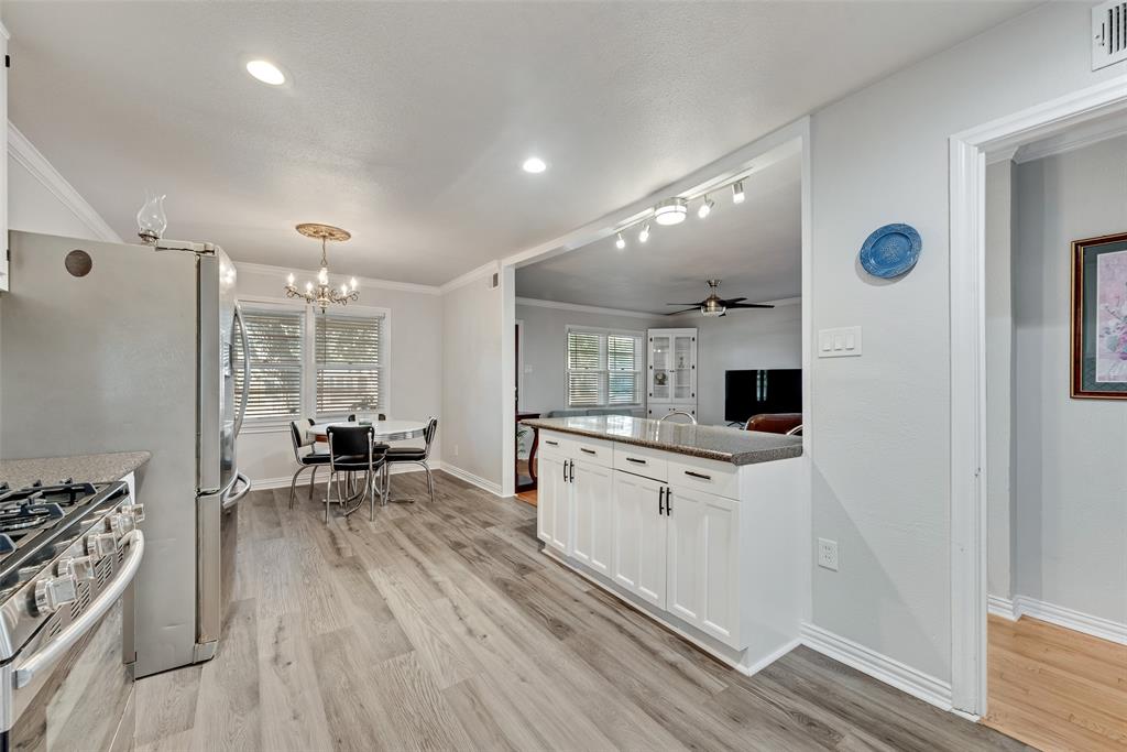 11310 Sinclair Avenue Dallas, TX 75218 - Photo 11 of 26 a kitchen with white cabinets and appliances