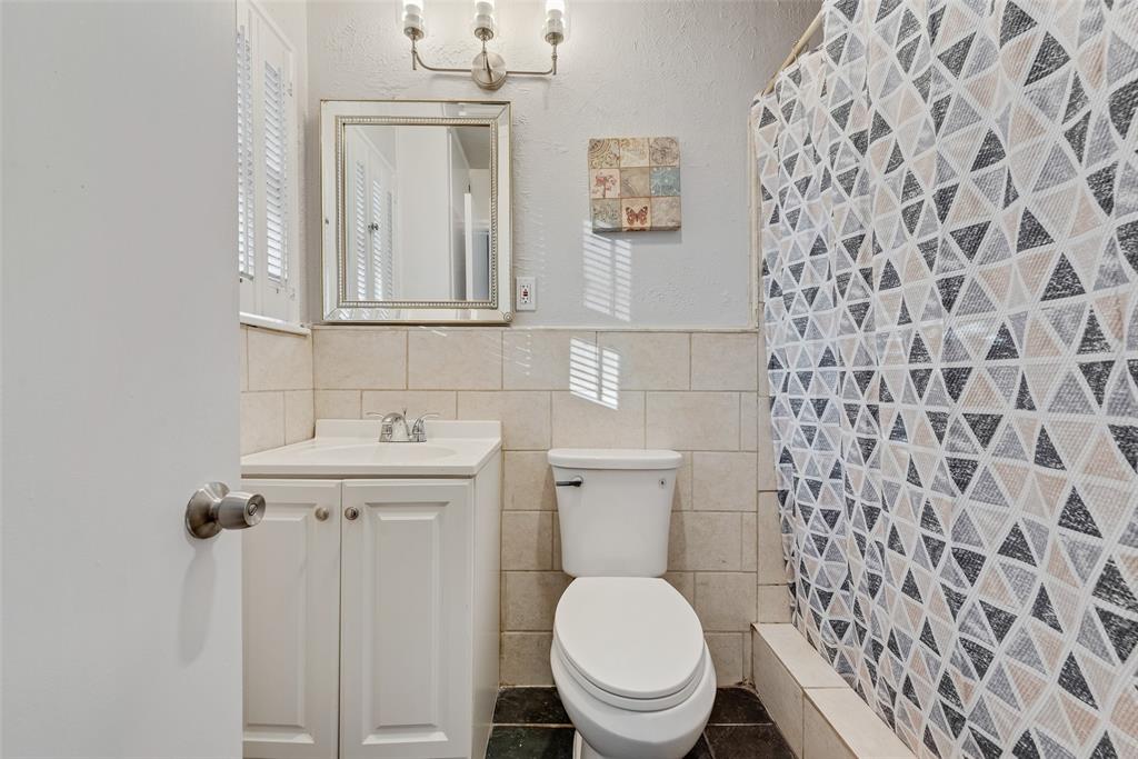 11310 Sinclair Avenue Dallas, TX 75218 - Photo 13 of 26 a bathroom with a toilet and a sink