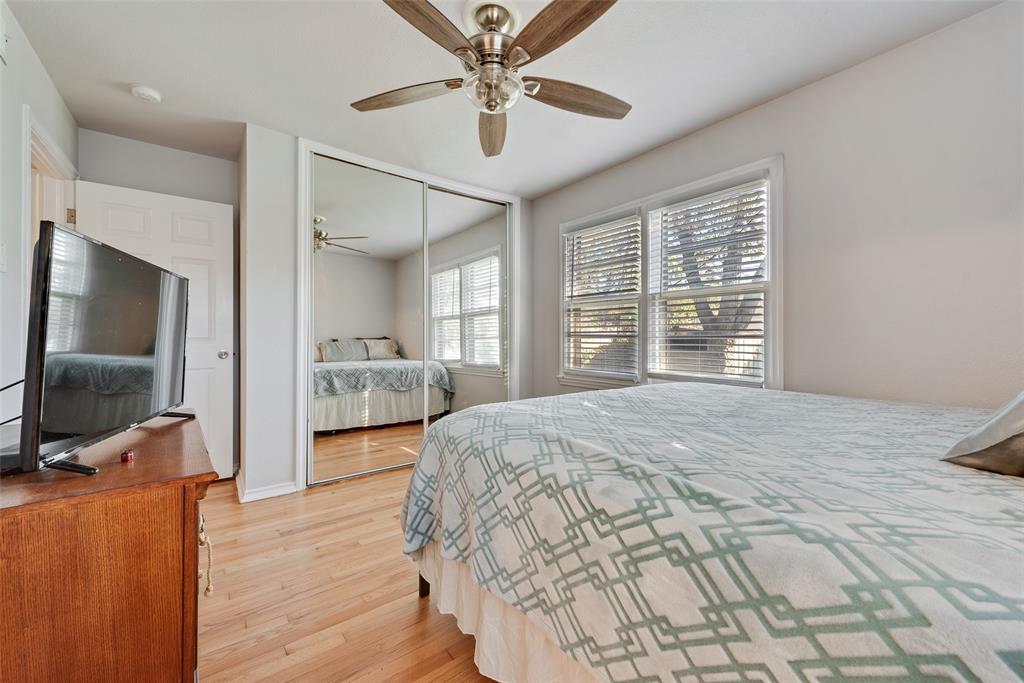 11310 Sinclair Avenue Dallas, TX 75218 - Photo 14 of 26 a bedroom with a bed window and a flat screen tv