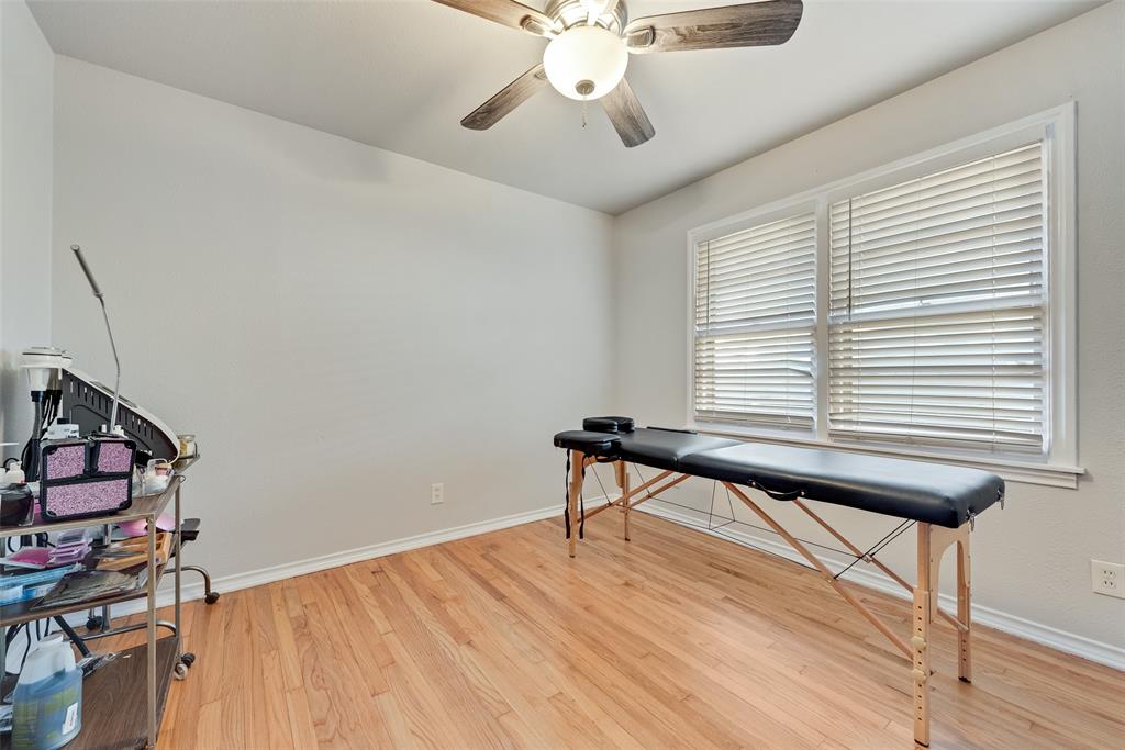 11310 Sinclair Avenue Dallas, TX 75218 - Photo 18 of 26 a room with chandelier fan and wooden floor
