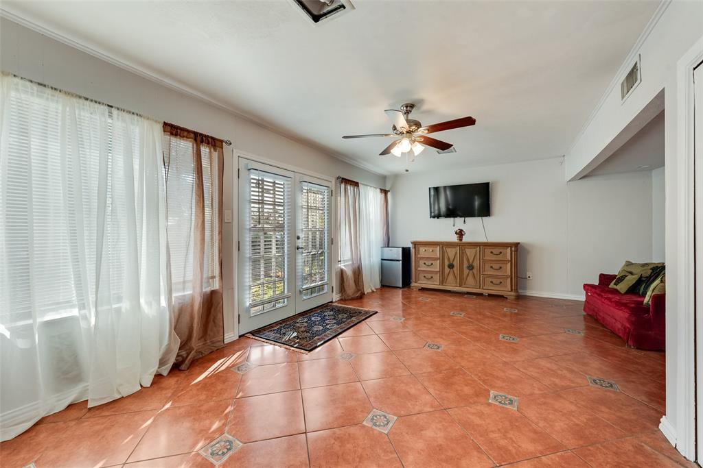 11310 Sinclair Avenue Dallas, TX 75218 - Photo 19 of 26 a living room with furniture and a flat screen tv