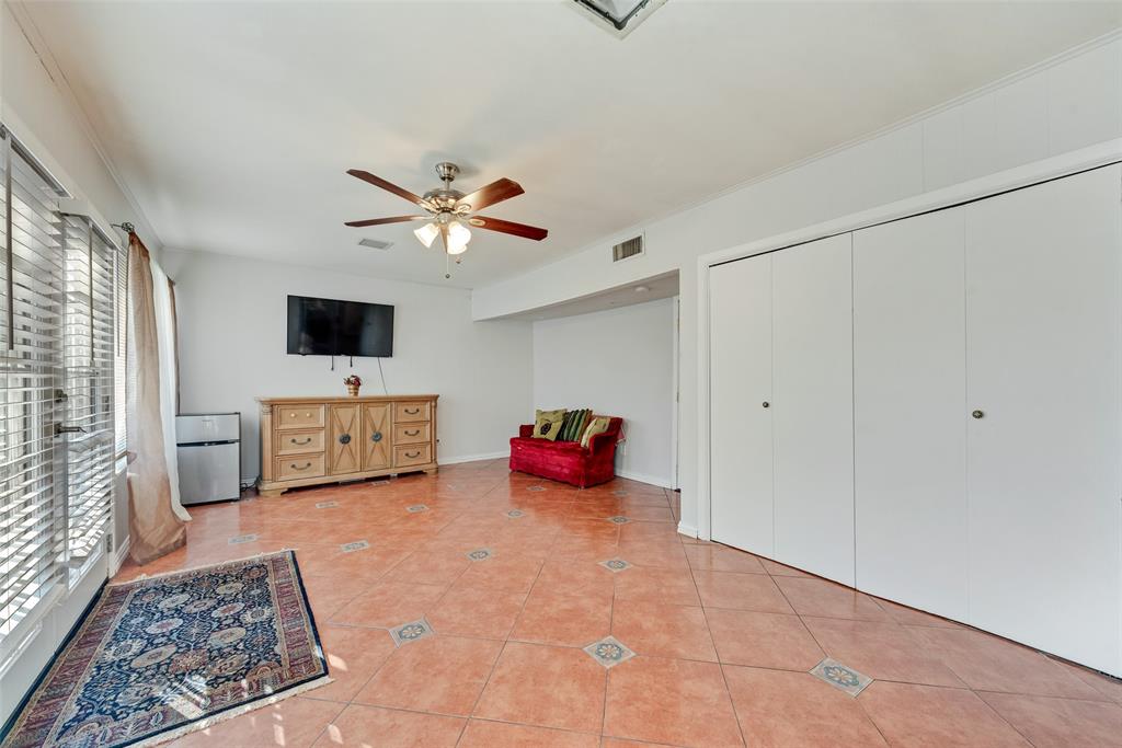 11310 Sinclair Avenue Dallas, TX 75218 - Photo 22 of 26 a living room with furniture and a flat screen tv