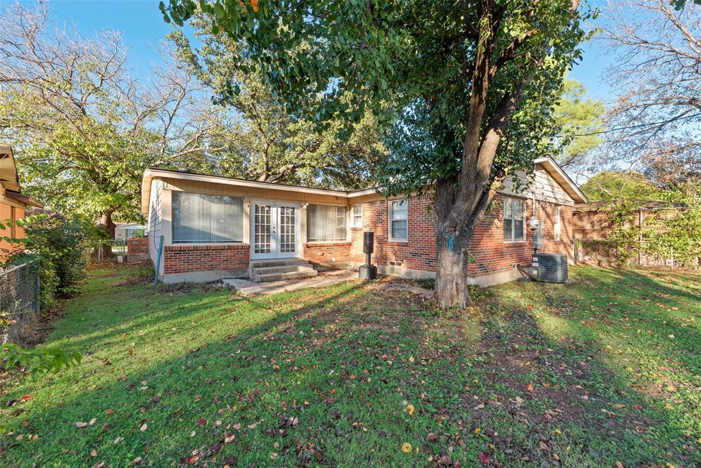 11310 Sinclair Avenue Dallas, TX 75218 - Photo 23 of 26 a view of a house with backyard and a tree