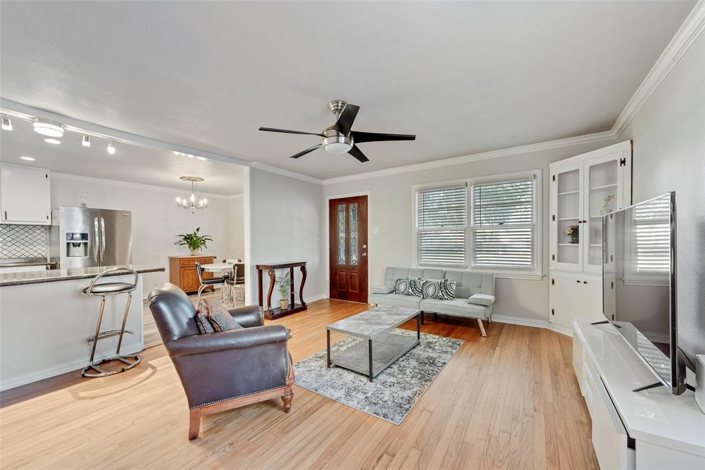 11310 Sinclair Avenue Dallas, TX 75218 - Photo 7 of 26 a living room with furniture floor to ceiling window and a flat screen tv