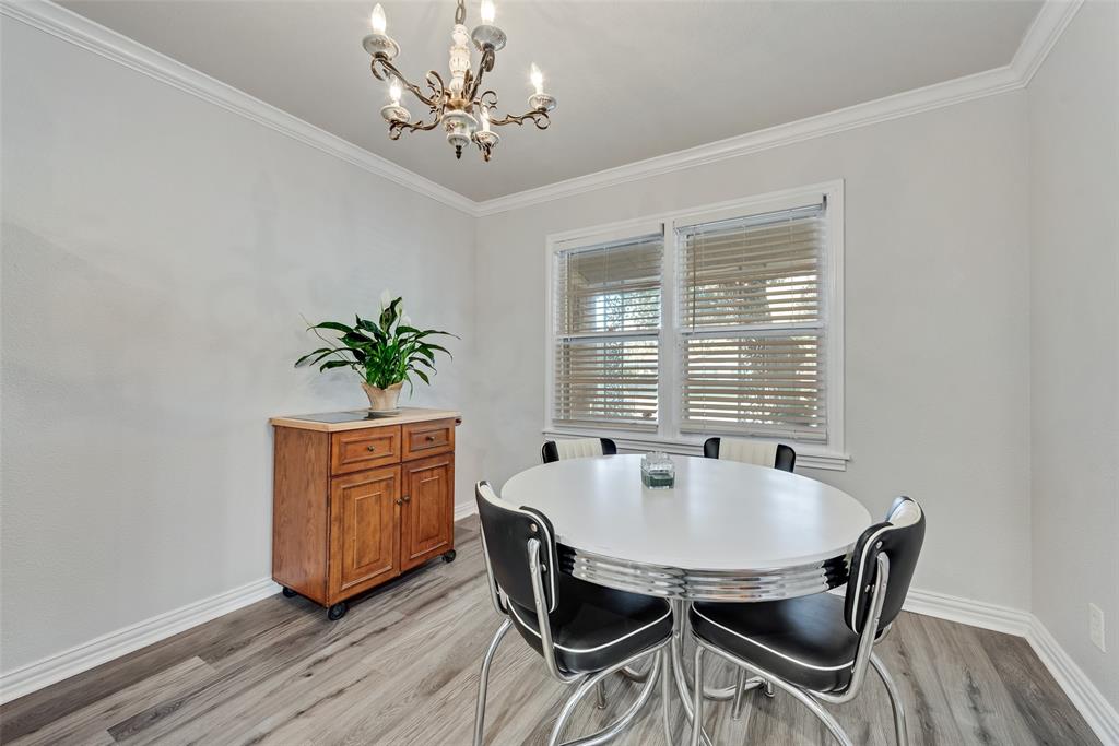 11310 Sinclair Avenue Dallas, TX 75218 - Photo 8 of 26 a view of a dining room with furniture window and wooden floor