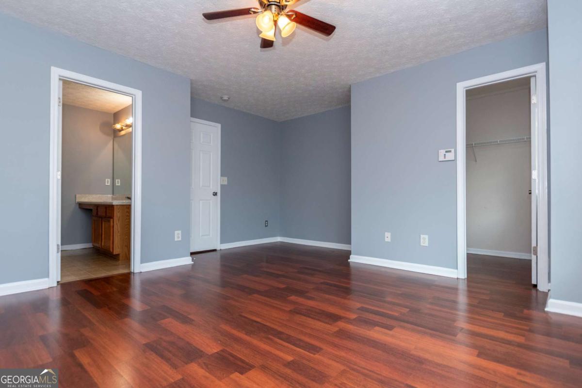 4123 Stone Trace Drive East Point, GA 30344 - Photo 11 of 24 wooden floor in an empty room with a window