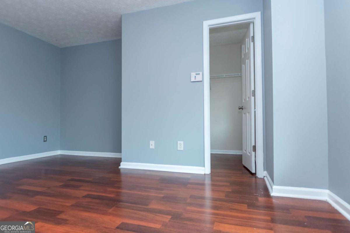 4123 Stone Trace Drive East Point, GA 30344 - Photo 13 of 24 a view of an empty room with wooden floor and closet