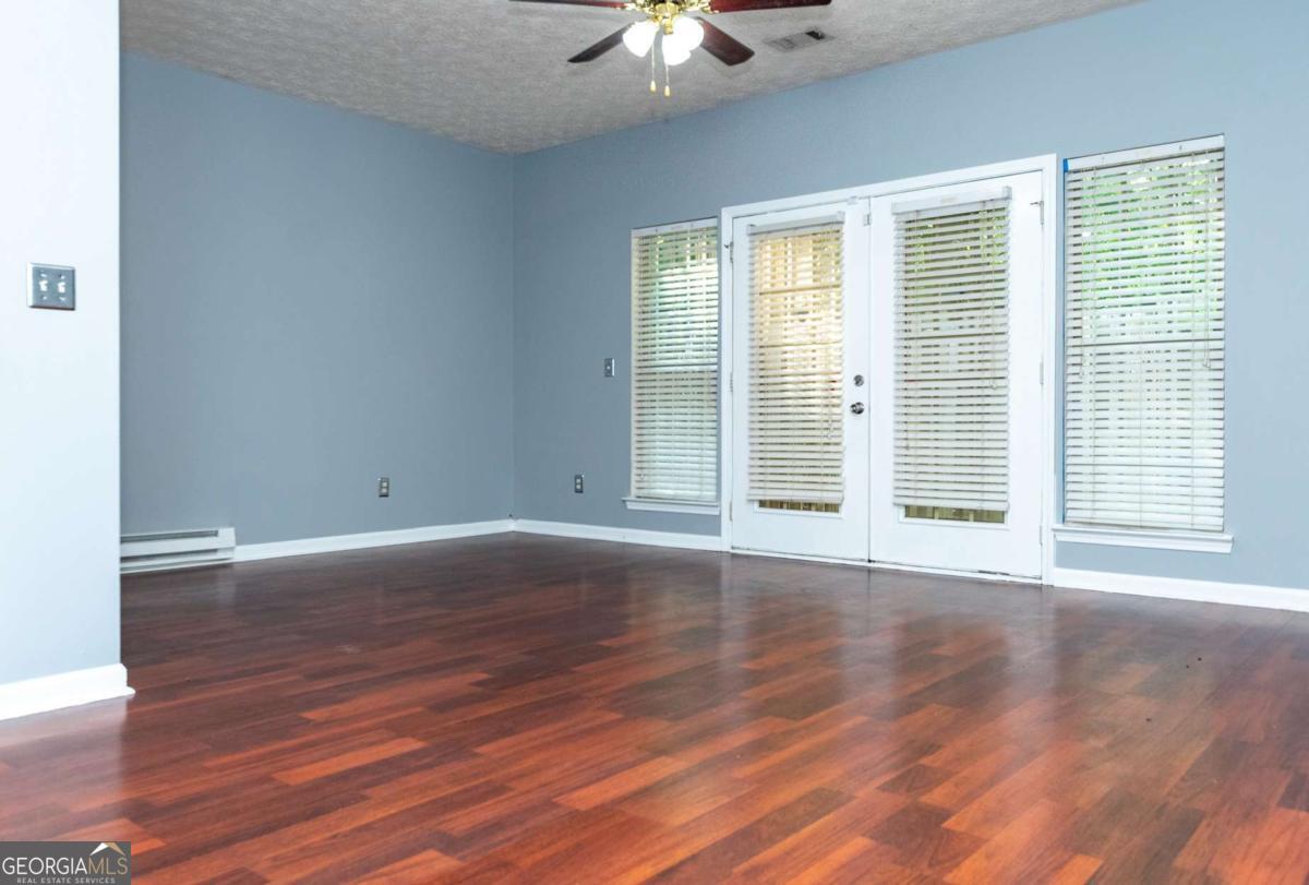 4123 Stone Trace Drive East Point, GA 30344 - Photo 16 of 24 a view of an empty room with wooden floor and a window