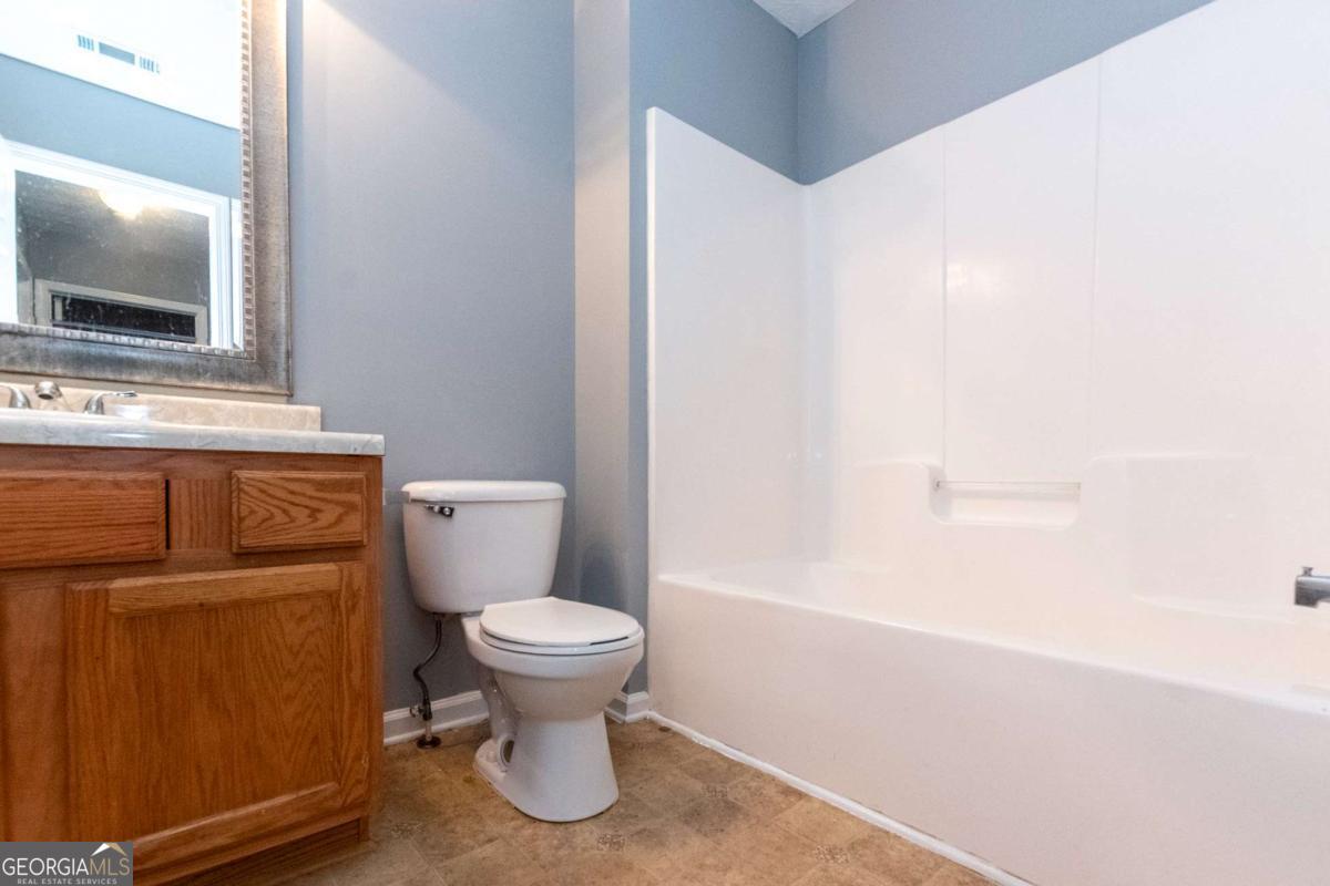 4123 Stone Trace Drive East Point, GA 30344 - Photo 4 of 24 a bathroom with a toilet sink and mirror