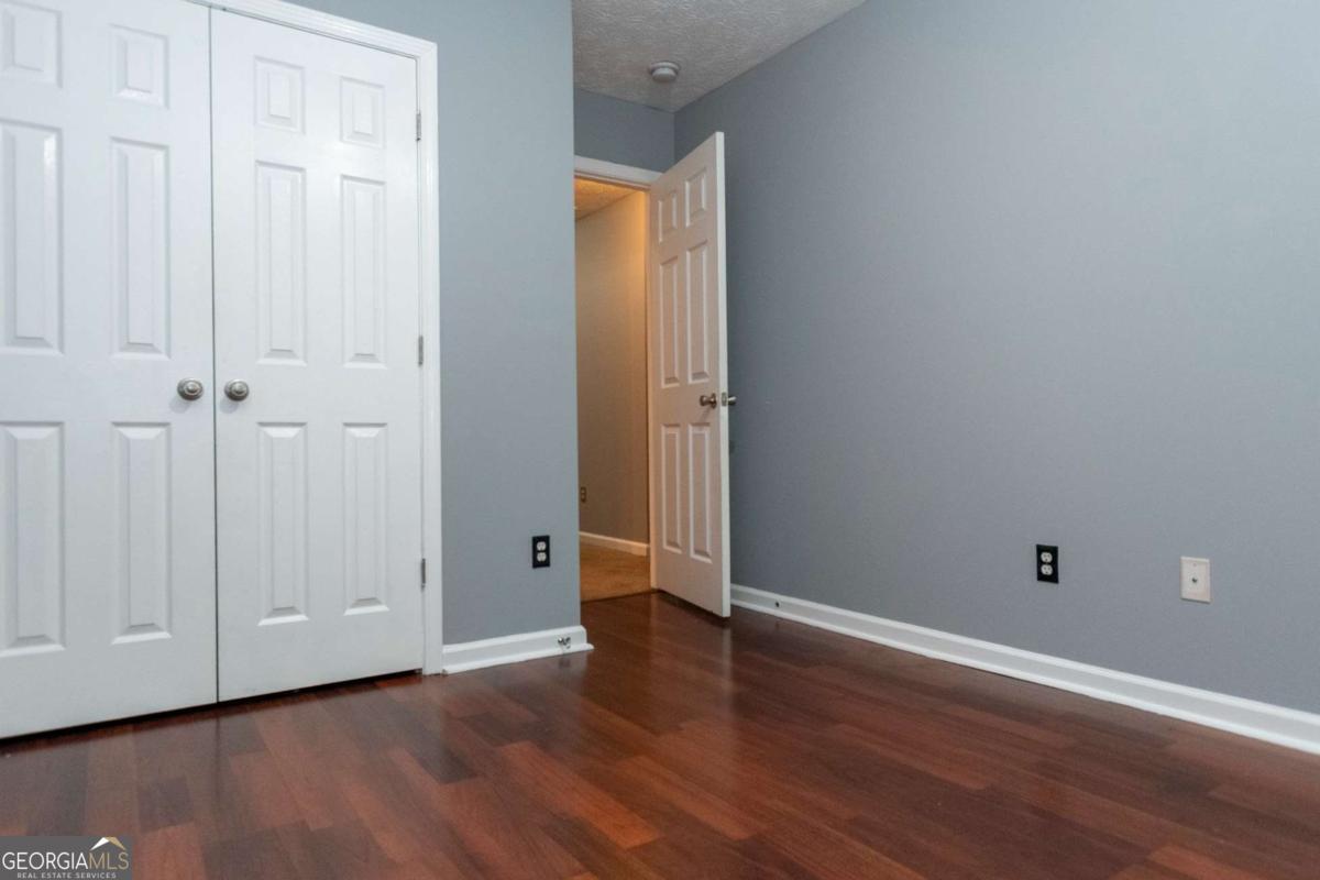 4123 Stone Trace Drive East Point, GA 30344 - Photo 6 of 24 a view of an empty room with wooden floor