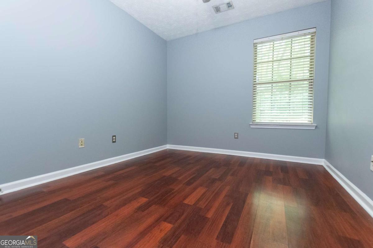 4123 Stone Trace Drive East Point, GA 30344 - Photo 8 of 24 a view of an empty room with wooden floor and a window