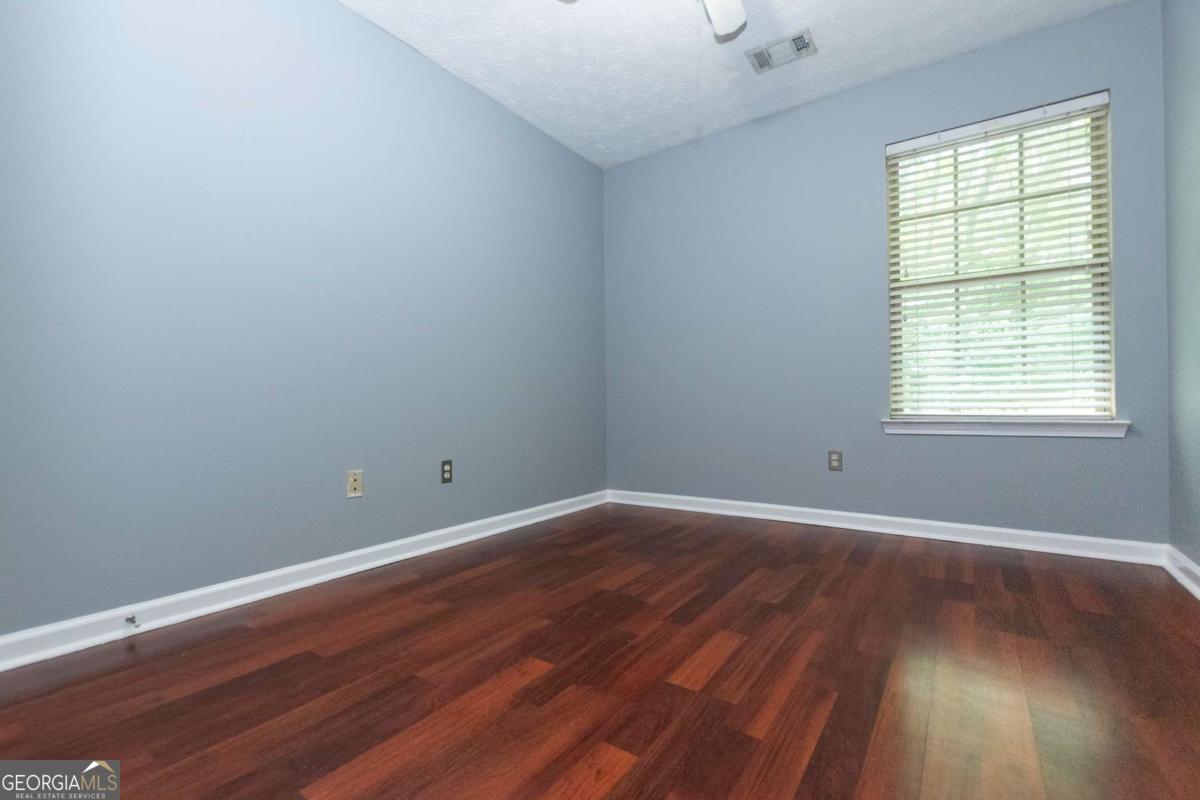 4123 Stone Trace Drive East Point, GA 30344 - Photo 9 of 24 an empty room with wooden floor and windows