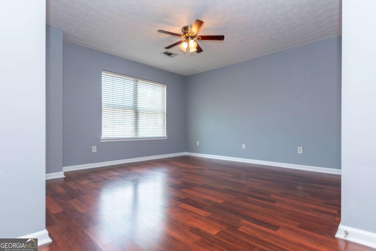 4123 Stone Trace Drive East Point, GA 30344 - Photo 10 of 24 an empty room with wooden floor and windows