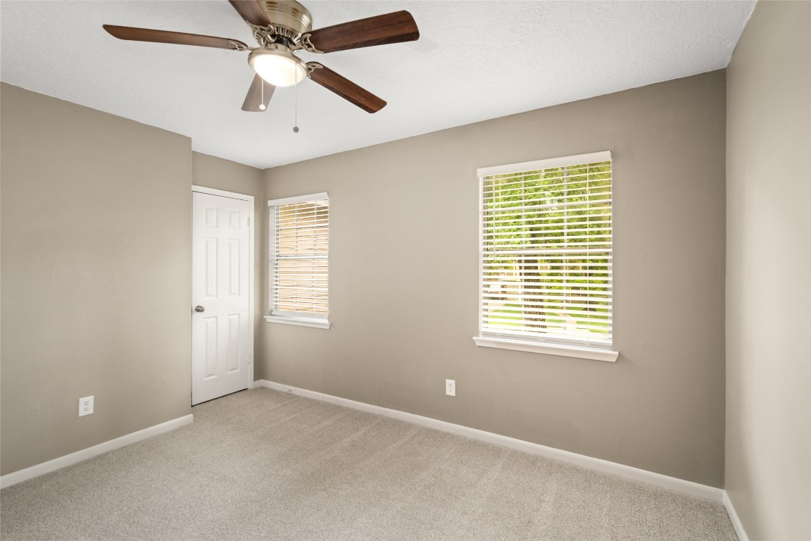 24915 Butterwick Drive Spring, TX 77389 - Photo 13 of 20 Your secondary bedrooms are large and comfortable, each featuring plush carpeting, a ceiling fan, and plenty of natural light.