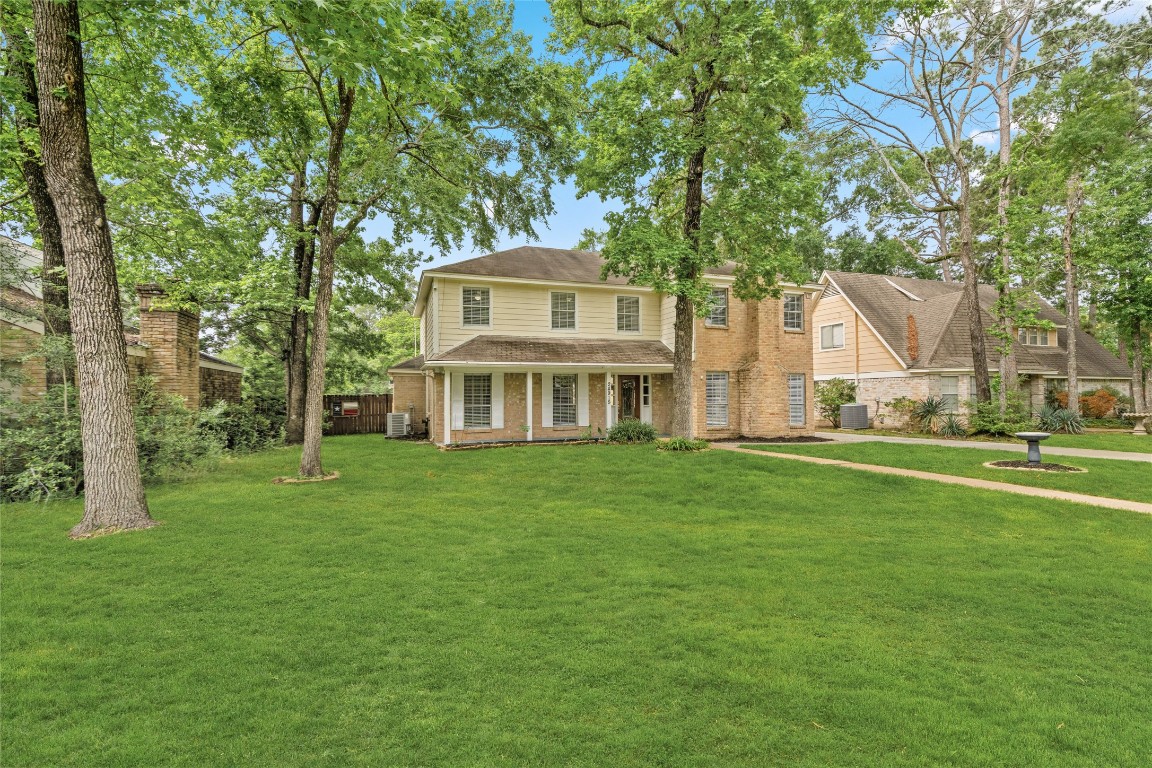24915 Butterwick Drive Spring, TX 77389 - Photo 18 of 20 Experience the beauty of an oversized lot! Your front yard offers a park-like setting with towering trees and a lush, green lawn.