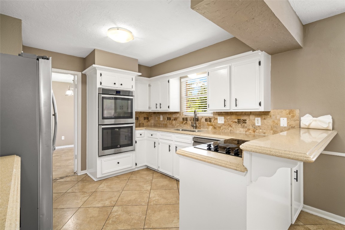 24915 Butterwick Drive Spring, TX 77389 - Photo 2 of 20 Your inner chef will adore this kitchen! With double ovens, crisp white cabinetry, and a layout designed for efficiency, meal prep becomes a joy.