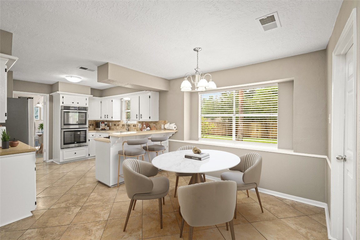 24915 Butterwick Drive Spring, TX 77389 - Photo 7 of 20 Enjoy your casual morning meals in this bright breakfast nook featuring a wide window with views of your expansive backyard. VIRTUALLY STAGED