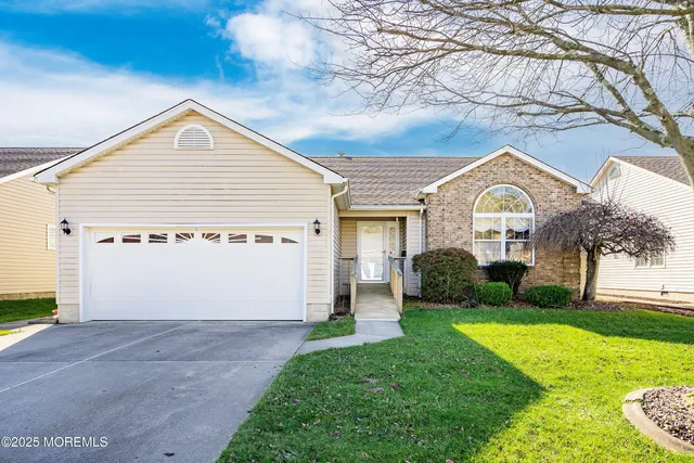 a view of house with yard and green space
