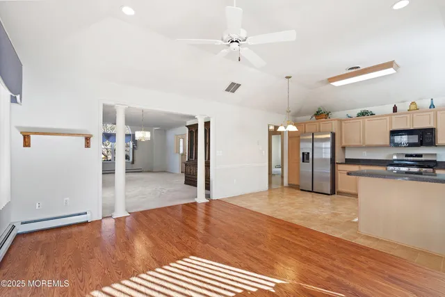 a view of a kitchen with a sink and a refrigerator