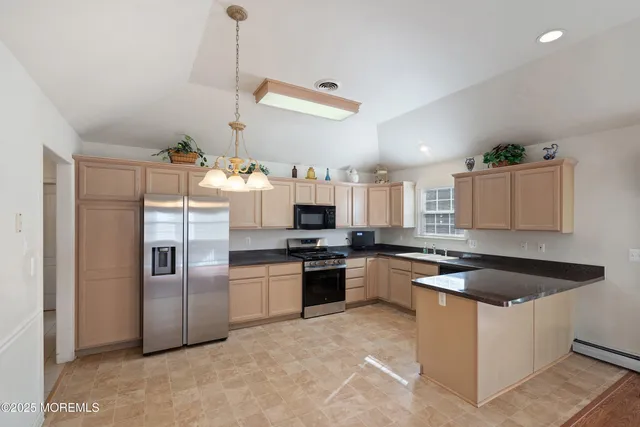a kitchen with granite countertop stainless steel appliances and a counter space