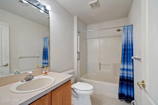 a bathroom with a sink toilet tub and shower