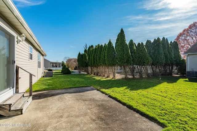 a view of a garden with large trees