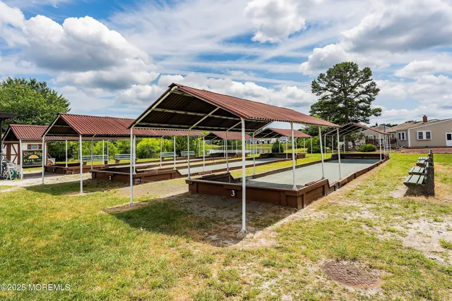 a view of a swimming pool with a bench in the patio