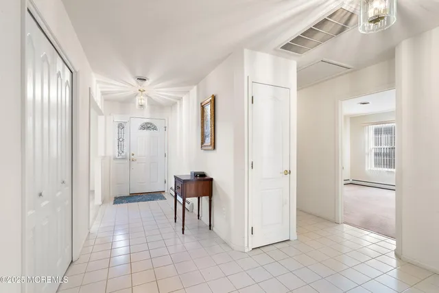 a view of a room with white walls and cabinet